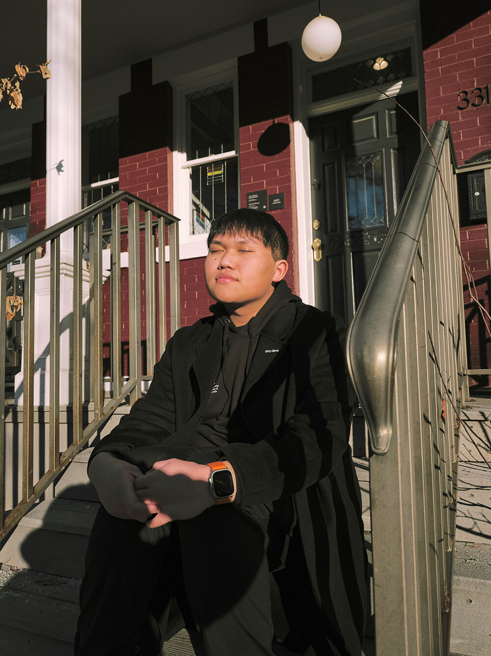 Man sitting in front of home Man sitting in front of home
